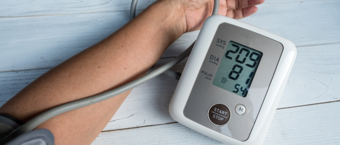 Stock image of an arm and blood pressure machine showing hypertension