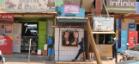 Entrances to several shops, including a butcher with meat hanging outside, in Uganda