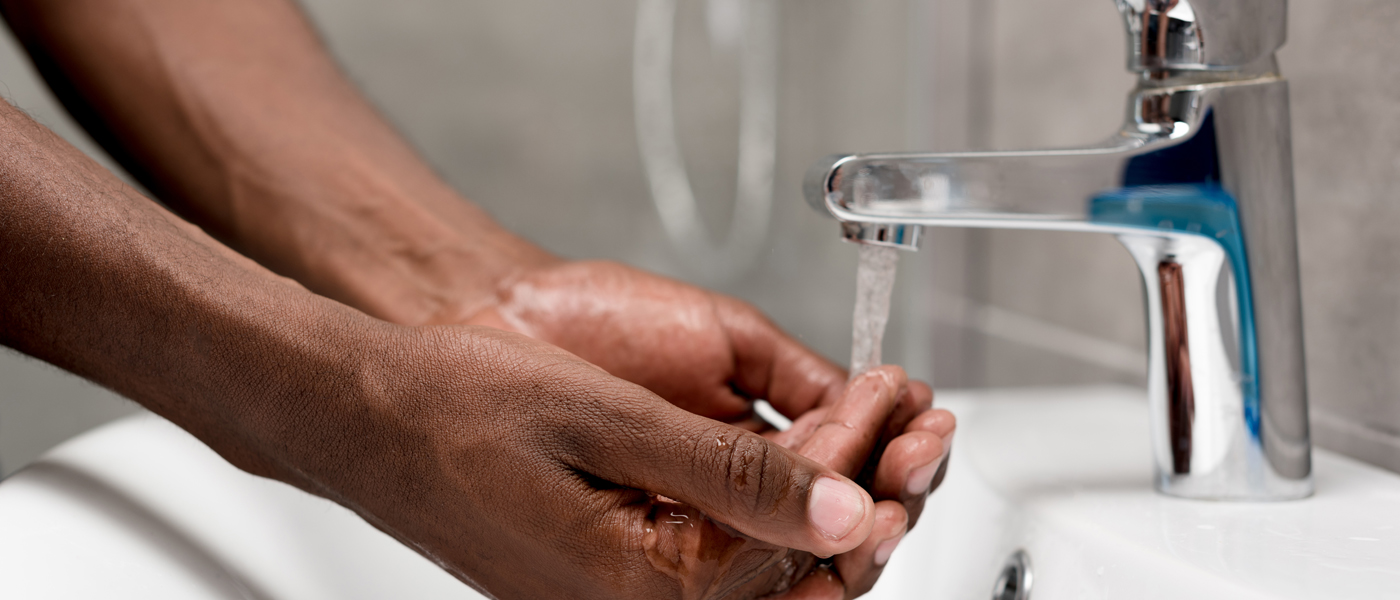 Photo of person washing hands at a sink