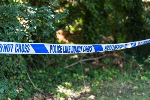 Photo of a police line 'do not cross' tape, crime scene
