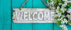 Photo of wooden welcome sign on garden shed