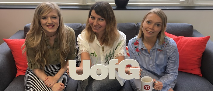 Alumni volunteering team on sofa with UofG sign