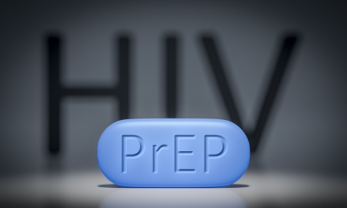 Blue prep pill in foreground, blurry HIV letters in black on white background