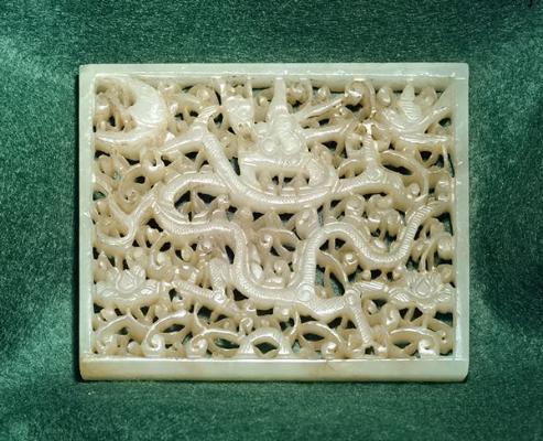 Jade; white nephrite plaque with thin dragon, birds, bat and peonies; carved.