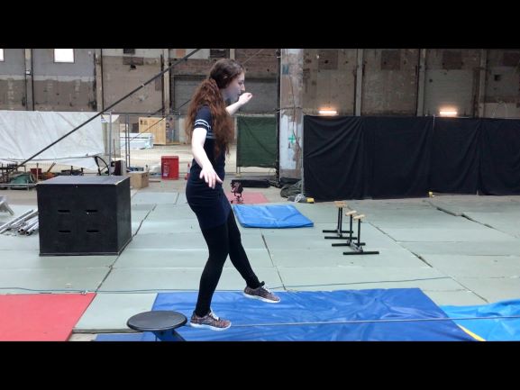 Young woman walking on a tightrope