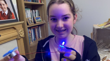 school pupil holding a light diode