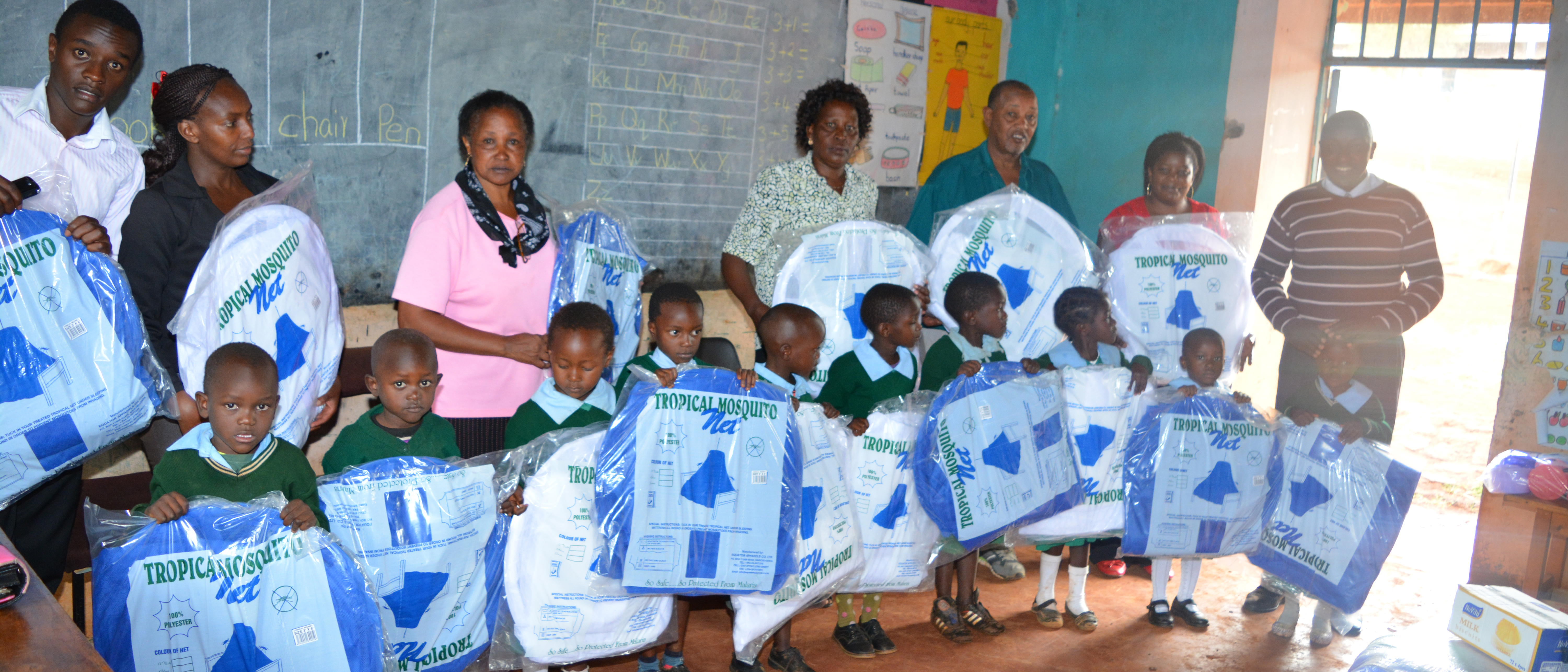 Children at the BION clinic in Kenya receiving their insecticide-impregnated bed nets as part of the malaria prevention programme.