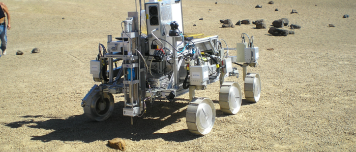 A robot mounted with an ultrasonic drill is tested in a desert