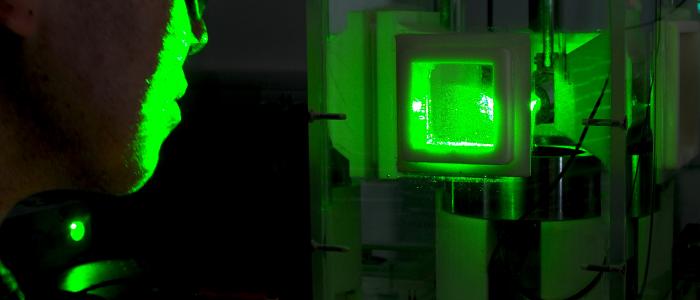 A person studies a laser cavitation experiment