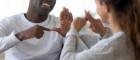 Photo of man and woman using BSL sign language