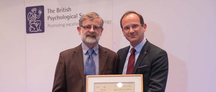 Photo of Professor Tom McMillan receiving an award from the British Psychological Society