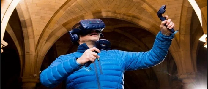 A student experiences VR in the University cloisters