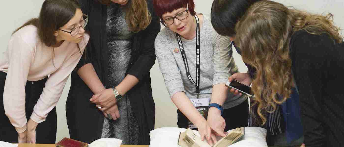 Group examining dye manuals in the University Archive and Special Collections
