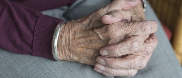 A clasped pair of elderly looking hands