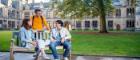 Students sitting on a bench on campus