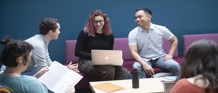 Students sitting together with laptop