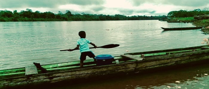 Boy on boat with paddle