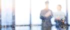 A blurred image of two business people collaborating on a project to symbolise the 'Our people' section of the cluster website.