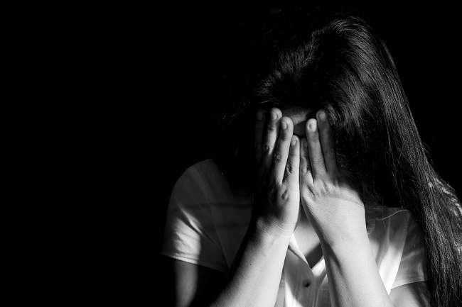 Women sitting upset with her head in her hands