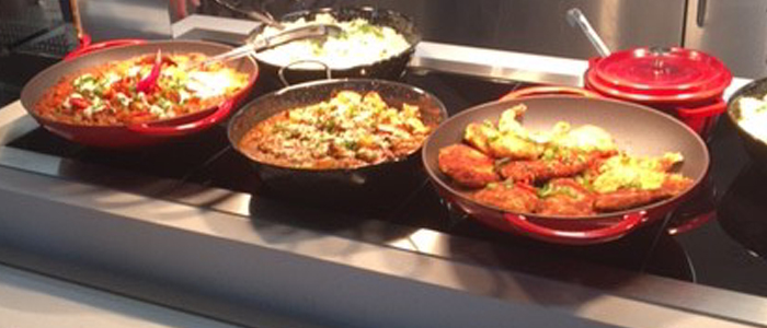 Prepared food on display sitting under heat plates