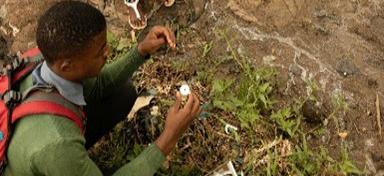 Camp resident performing water quality testing in Dzaleka refugee camp