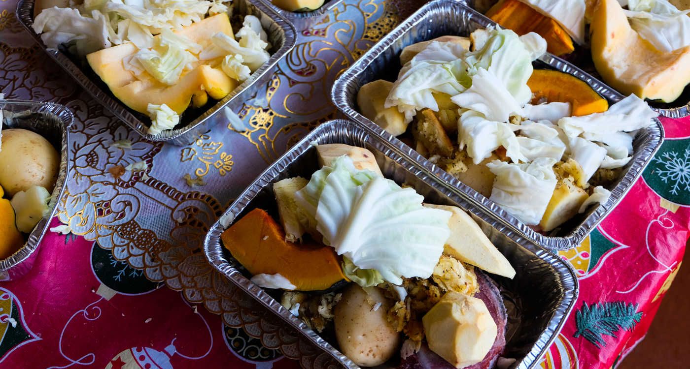 Traditional Maori food hangi portioned out into containers [Photo: Shutterstock]