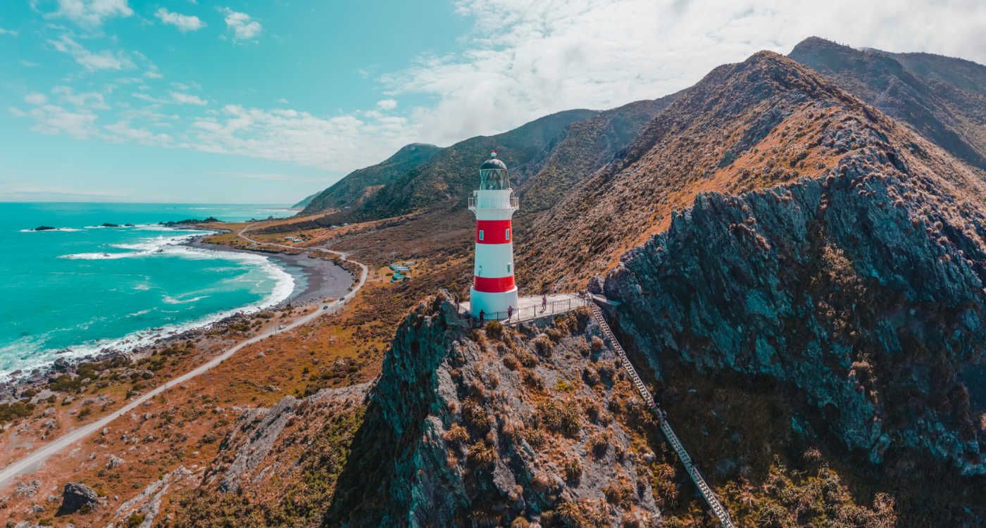 Palliser lighthouse with a steep, long staircase leading up the hill to it [Photo: Shutterstock]