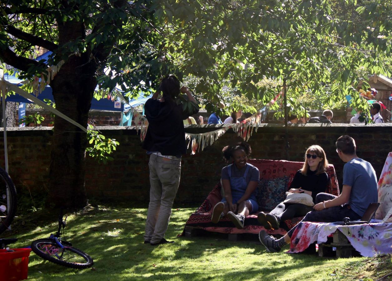 Students enjoying the sunshine in the Viewfield Lane gardens during a summer festival