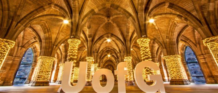 The University Cloisters with fairy lights around the pillars and large UofG letters on display