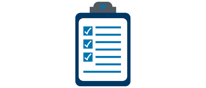 An image of a clipboard with ticked items and writing