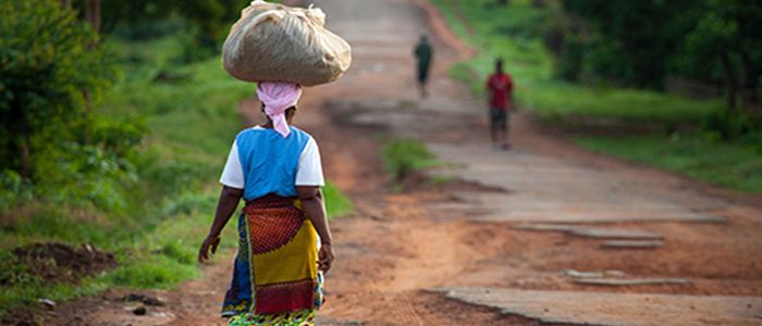 lady walking carrying items on head