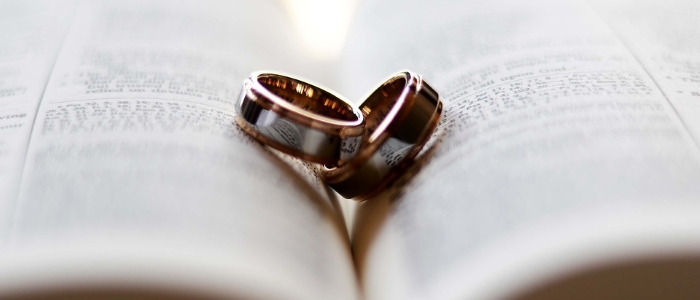 Wedding rings on open book
