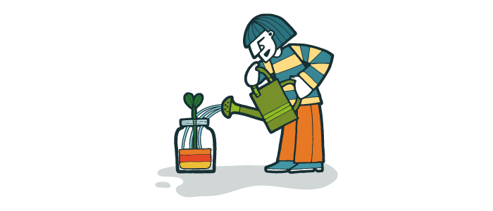 Person with watering can watering a plant in a glass jar