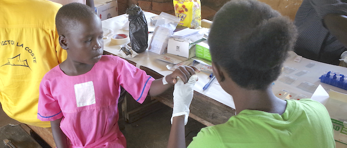 A primary school child in Uganda has her blood taken for use in the new origami diagnostic system 