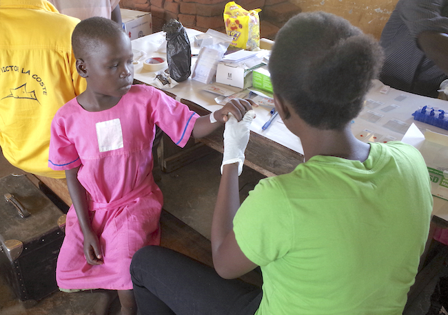 A primary school child in Uganda has her blood taken for use in the new origami diagnostic system