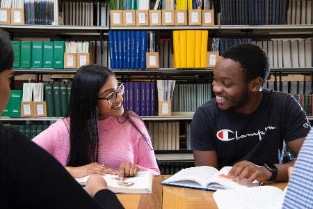 Students smiling in library on Dumfries Campus