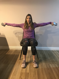 woman sitting lifting weights