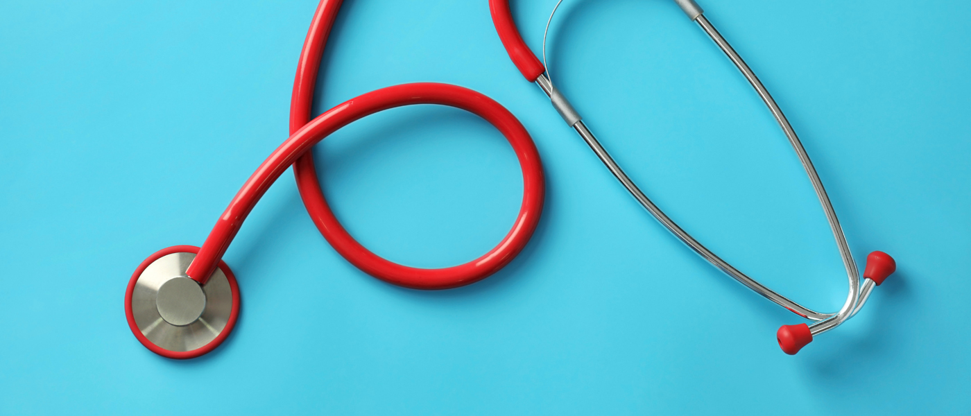 Photo of red stethoscope on blue background
