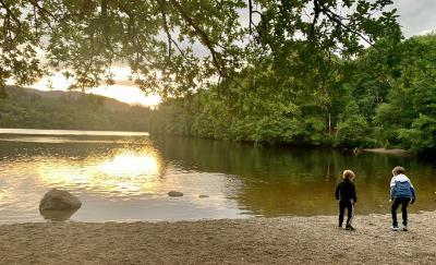 Photo of two children standing by a lake