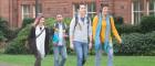 Four students walk through the Dumfries Campus