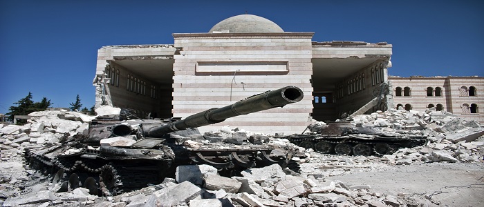 A tank outside building rubble 