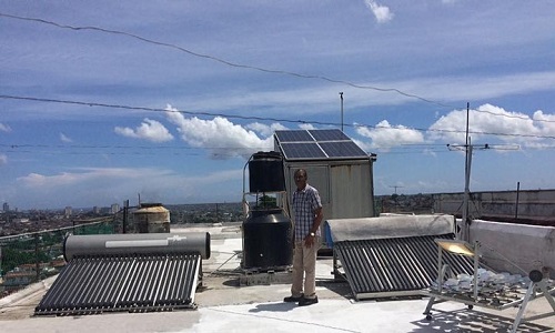 Man standing between two solar devices