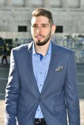 Phto of Ilias Koutroulis standing wearing a suit