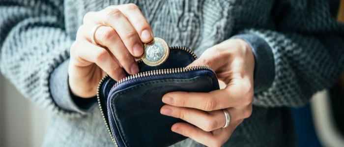 Image of woman putting a coin into a purse