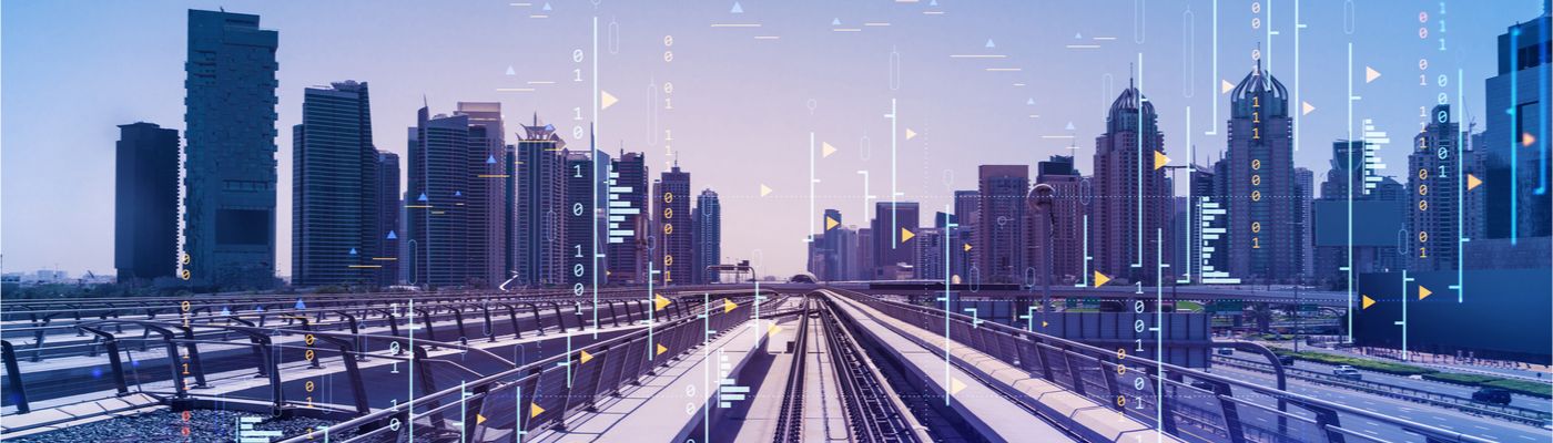 Image of modern train tracks in front of skyscrapers