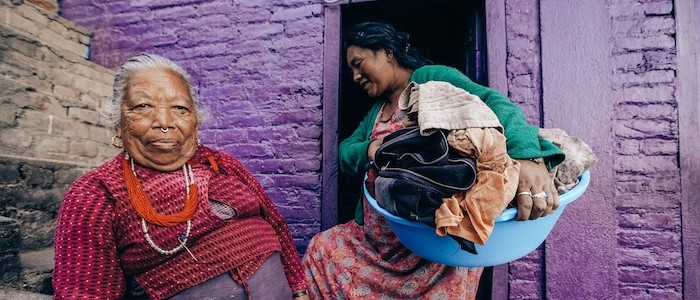 Image of an elderly woman and young woman doing laundry 