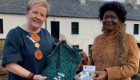 An image of Alex Mackay and the First Lady of Malawi standing together during the presentation of the UofG quaich 