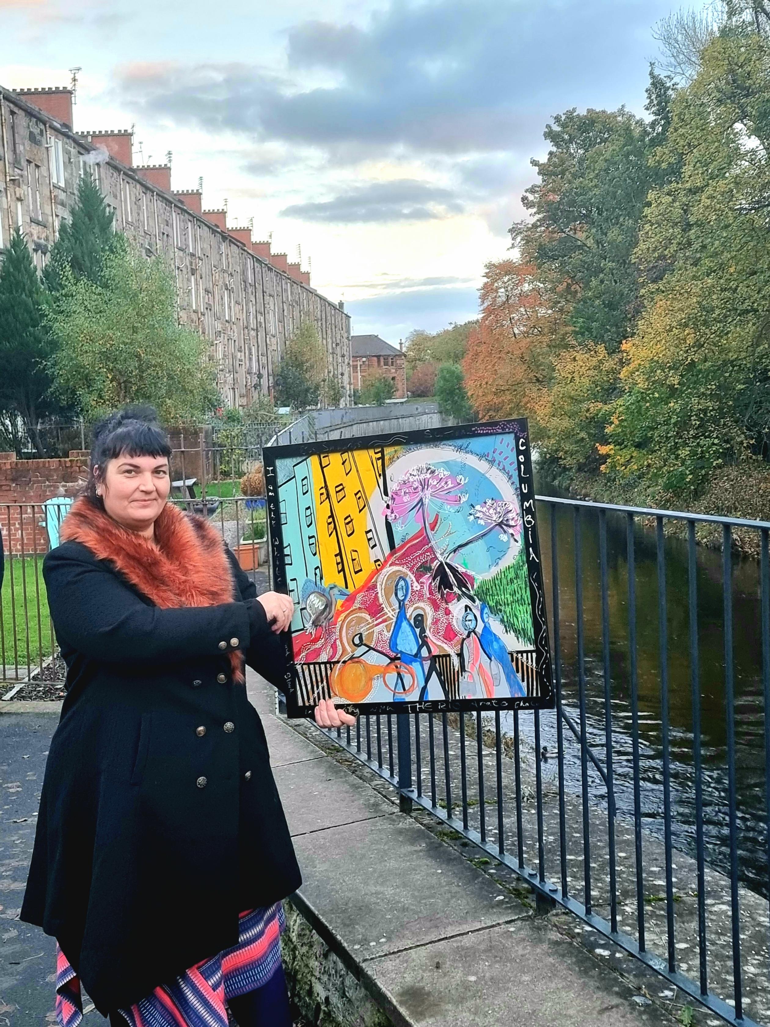 Woman holding abstract painting by the White Cart river