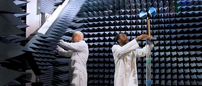 Image of Tom O'Hara and phd student working in the anechoic chamber