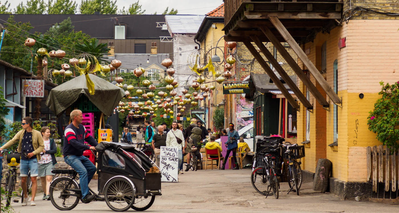 Street in Freetown Christiania with people and bikes in the street [Photo: Shutterstock]